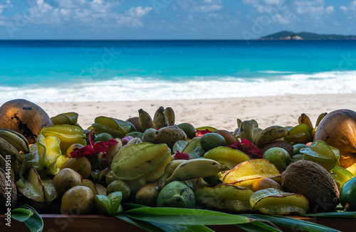 Tropical fruits on a sandy beach against the background of the sea