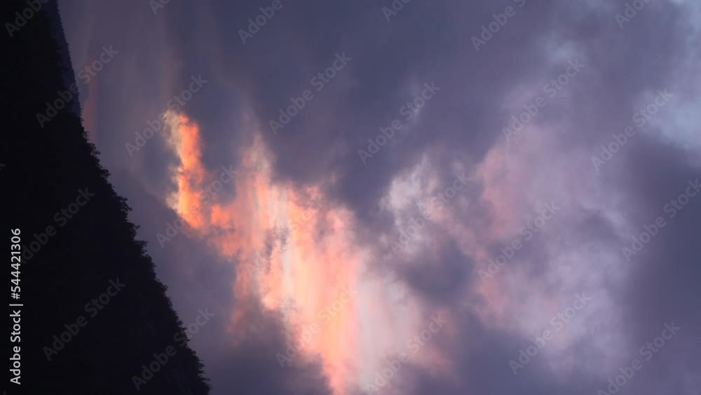 Vertical video view of mountains and forest during purple-pink sunset. Cloud movement in the middle of the sky Vertical video view of mountains and forest during purple-pink sunset. Cloud movement in the middle of the sky