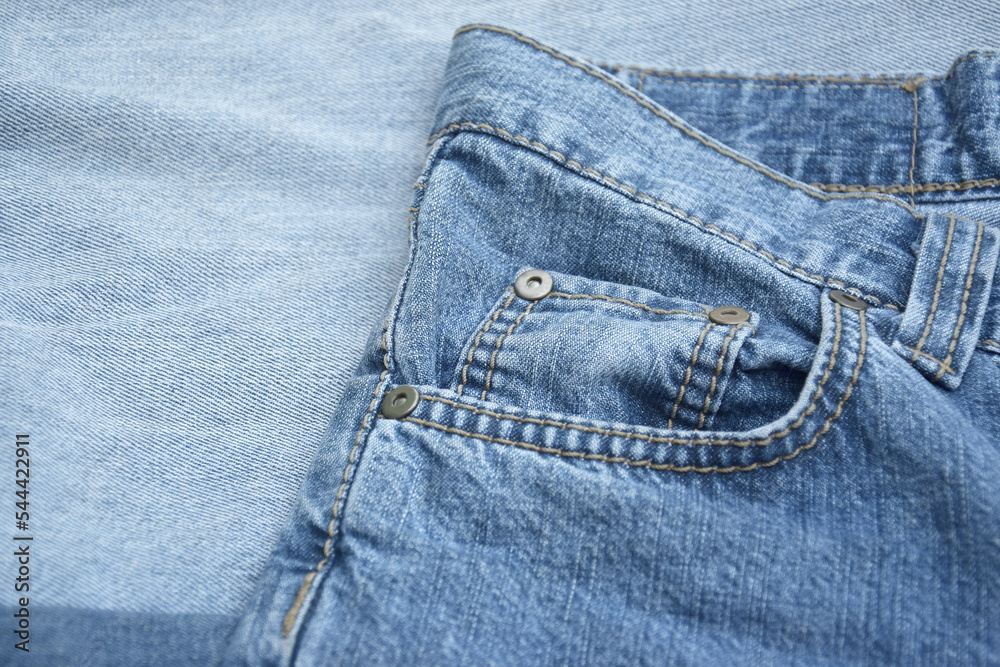 Fototapeta premium Lots of jeans pants in a stack. Denim background.