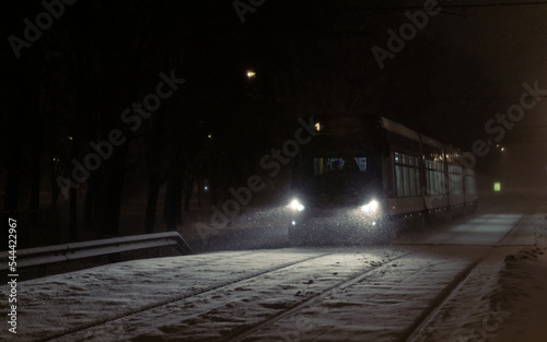 Night tram in winter during a blizzard. public transport on a winter night