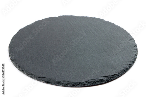 black slate round board for serving cheese and snacks on a white background