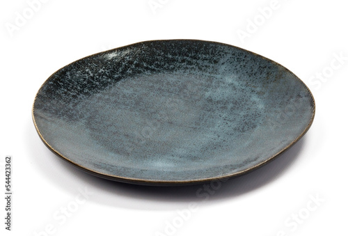 ceramic dark blue flat round plate with black blotches (dots, paint splashes, spots) close-up on white background