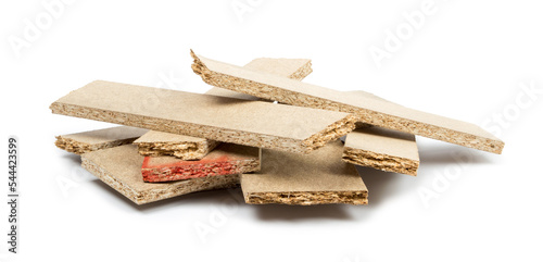 a pile of broken untreated mdf slabs of brown color on a white background close-up