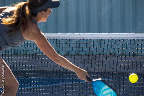 People Playing pickleball outdoors.   photo