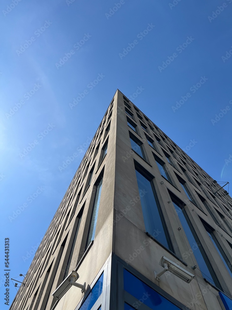 the corner of the building with large windows on the background of the sky the corner of the building with large windows on the background of the sky