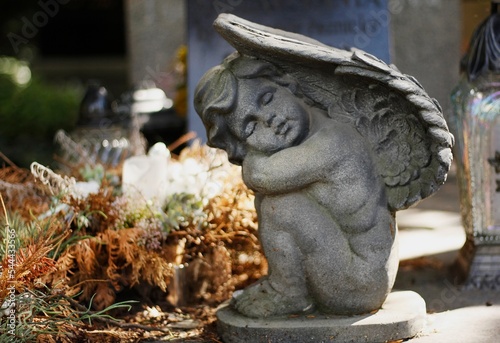 Stone statue of a little angel in a cemetery