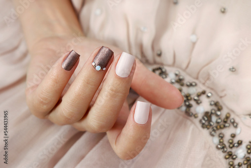 Milk chocolate manicure with rhinestones on short nails.