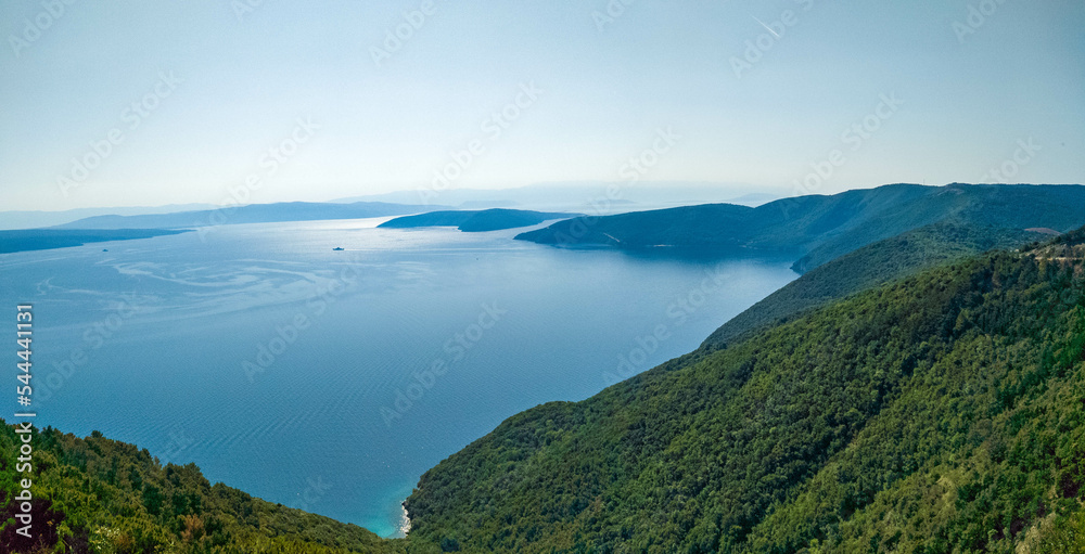 Mountainous coastline of island Cres covered with forest and pristine sea