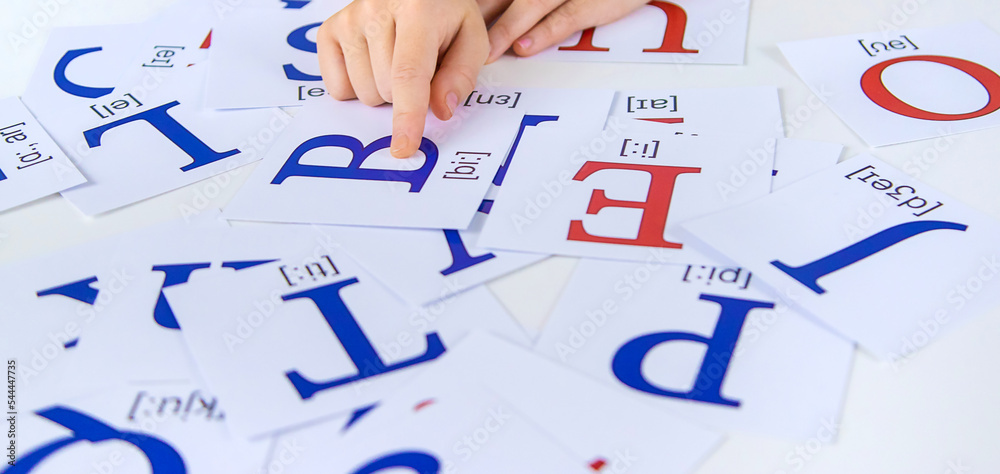 Fotografie The child learns English letters. Selective focus.