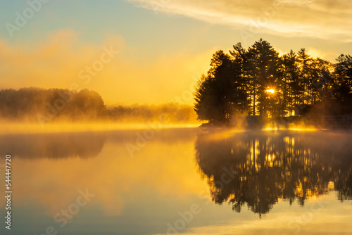 Fototapeta Naklejka Na Ścianę i Meble -  Beautiful golden sky reflected in a lake in autumn