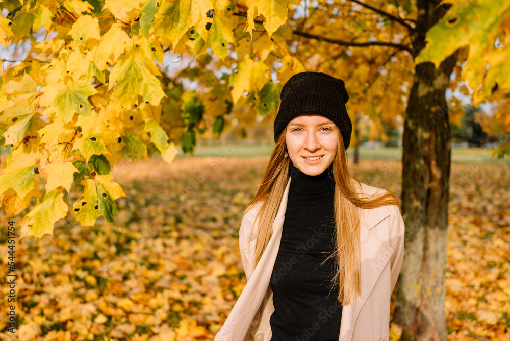 young beautiful girl is resting in nature. woman walking in the park on an autumn day