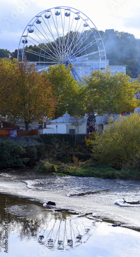 Riesenrad im Herbstnebel mit Spiegelung im Wasser der Lahn photo