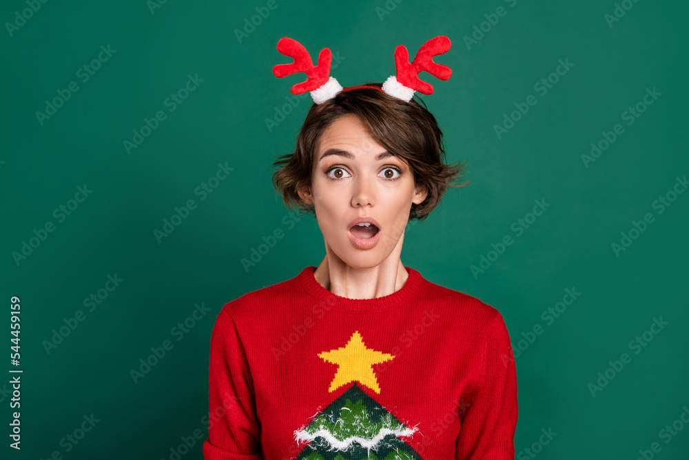 Photo of shocked funky lady wear red sweater horns hair band open mouth isolated green color background Photo of shocked funky lady wear red sweater horns hair band open mouth isolated green color background