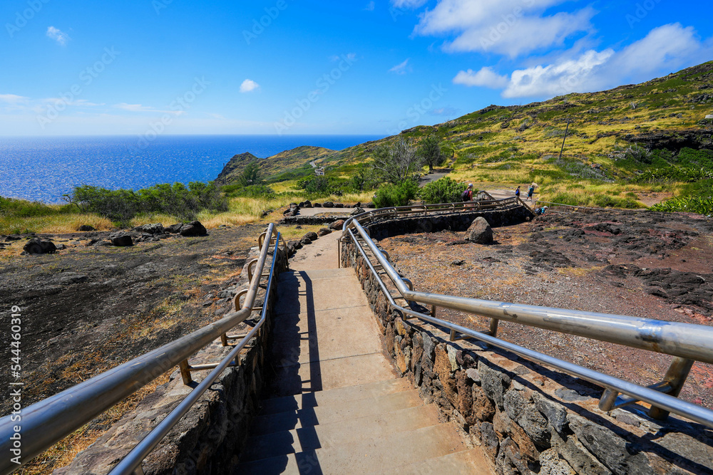 Makapu'u Point's overlook allows tourists to enjoy breathtaking views over the dramatic cliffs of the eastern side of Oahu island in Hawaii, United States
