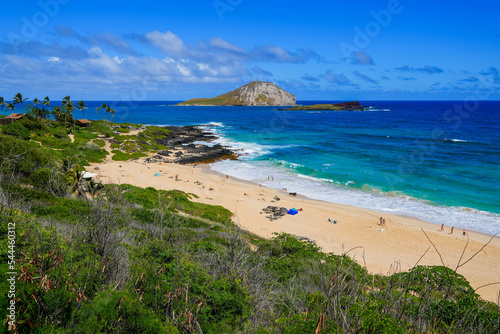 Beautiful white sand beach and translucent waters with a view over Manana Island and Kaohikaipu Islet seabird sanctuaries in Makapu'u Beach Park on the eastern side of Oahu island in Hawaii, USA