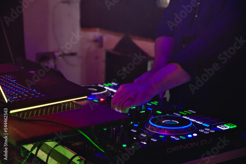 the hands of a dj mixing music on the cdj