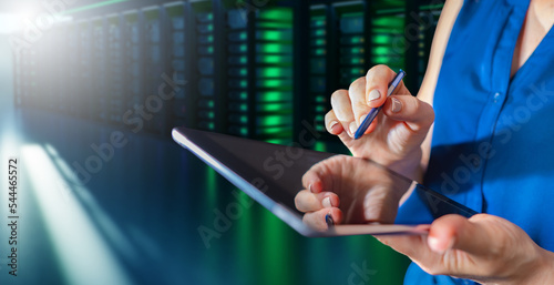 Tablet in woman hands. Hosting provider manager. Girl oversees work of server equipment. Woman with electronic tablet in it company. Server rental concept. Servers for hosting company
