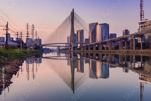 View of Pinheiros River With Modern Buildings Alongside and Famous Octavio Frias de Oliveira Bridge in Sao Paulo City photo