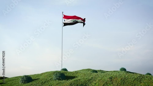 Iraq flag waving in the wind on a beautiful landscape. Blue sky. 4K HD. Stunning image. photo