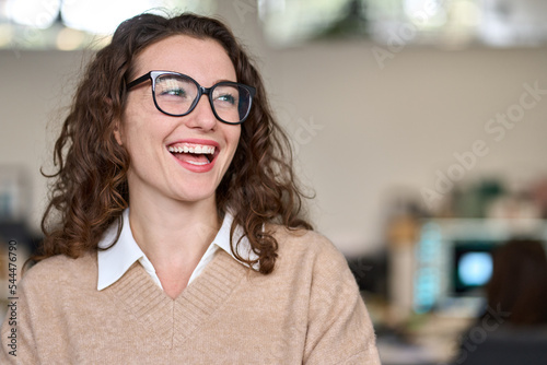Φωτογραφία Young happy cheerful professional business woman, happy laughing female office worker wearing glasses looking away at copy space advertising job opportunities or good business services or optic store