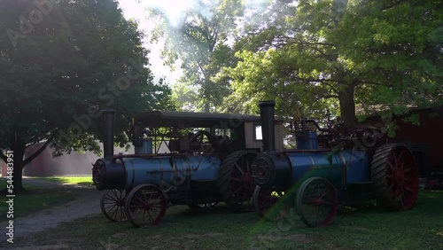 Kinzers, Pennsylvania - August 18, 2022: Two historic steam engines sitting under a tree at Kinzers Threshermans Reunion. photo