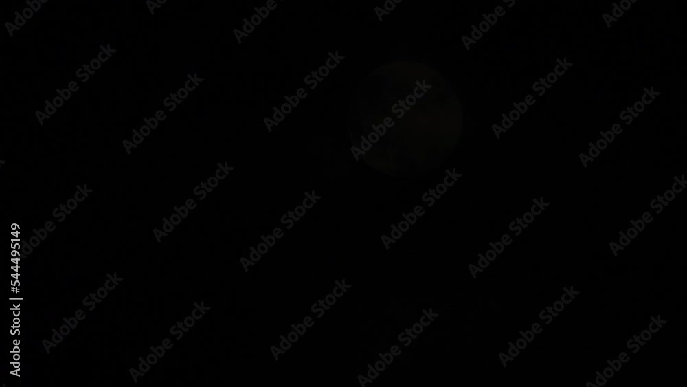Glowing full Moon dark sky with moving clouds Glowing full Moon dark sky with moving clouds