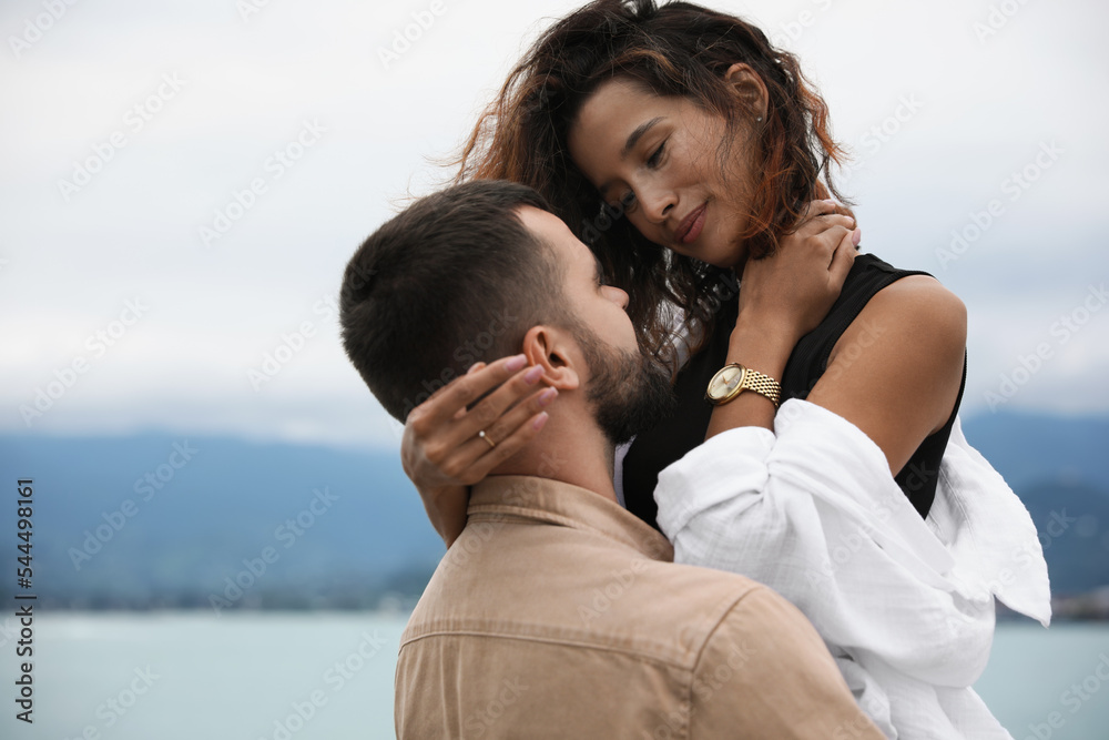 Beautiful young couple enjoying time together on beach, space for text Beautiful young couple enjoying time together on beach, space for text