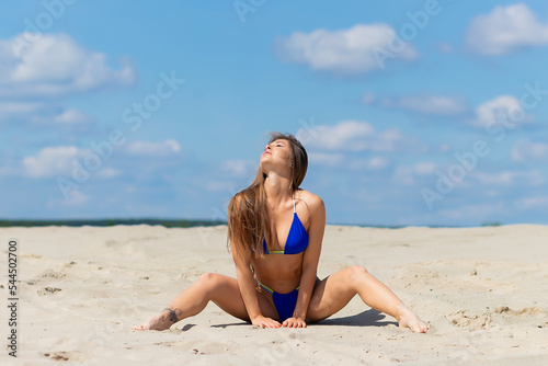 Charming woman in bikini on beach