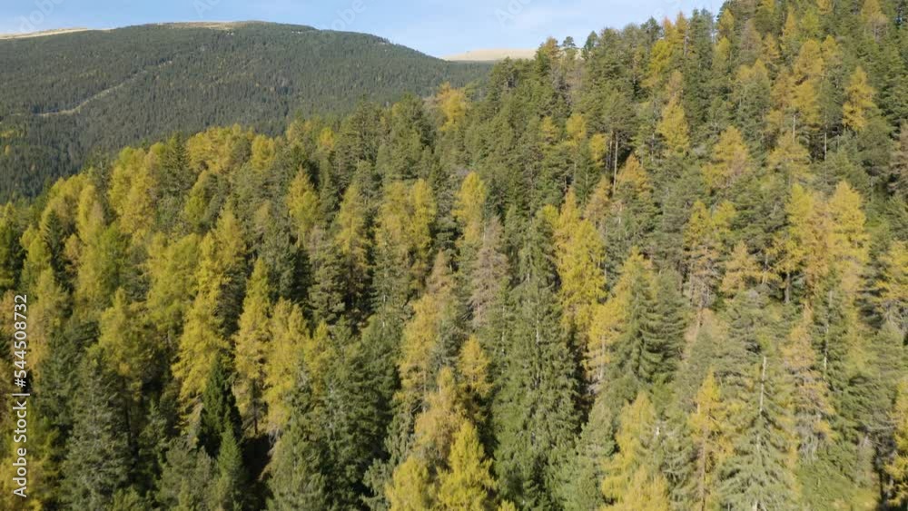 Aerial Flight Above Colorful Trees Reveals Tiny Village in Valley Below. Italy Aerial Flight Above Colorful Trees Reveals Tiny Village in Valley Below. Italy