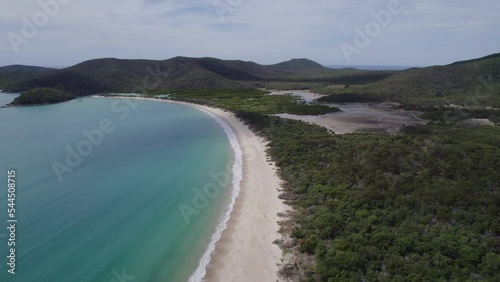 Scenic Beach With Turquoise Sea Waves Splashing On Shore At Great Keppel (Wop-pa) Island In Queensland, Australia - aerial drone shot photo