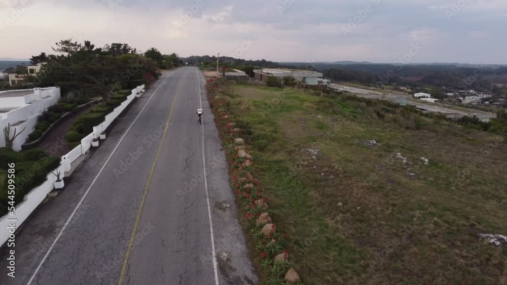 circular drone flight over an ascending asphalt road with a cyclist circular drone flight over an ascending asphalt road with a cyclist