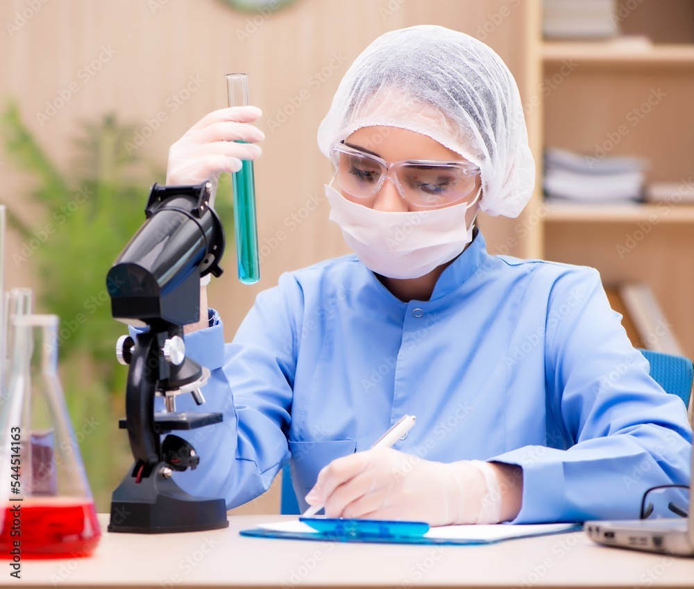 Lab chemist working with microscope and tubes Lab chemist working with microscope and tubes