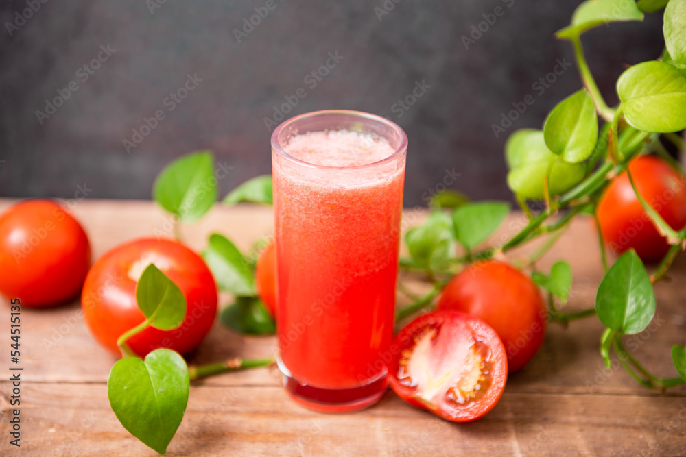 Fresh tomato juice on wooden table Fresh tomato juice on wooden table