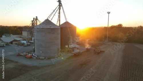 Grain elevator in USA at harvest. Fall golden hour light. Aerial establishing shot of rural agriculture theme in USA. photo