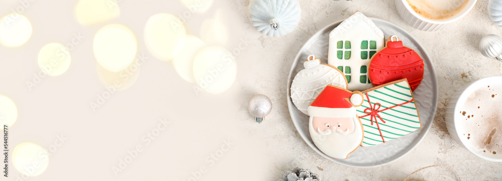 Plate of sweet Christmas cookies on light background with space for text