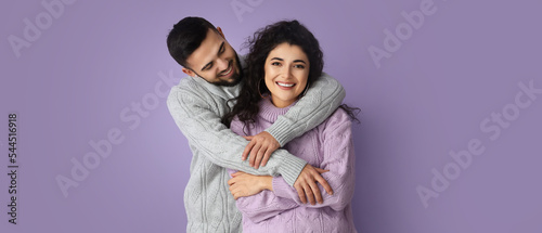 Happy young couple in warm ...