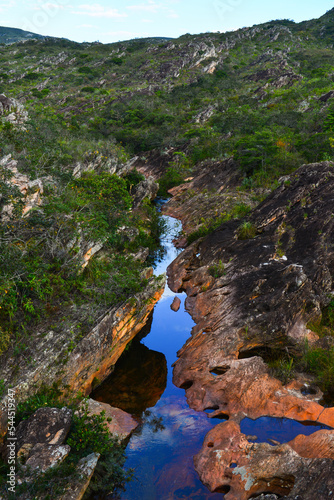 A creek flowing through the rocky landscape near the Cachoeira dos Cristais waterfall, on the way to the historic village of Biribiri, Diamantina, Minas Gerais state, Brazil