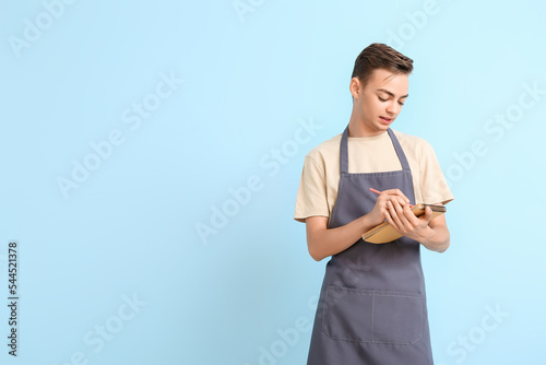 Male barista writing in not...