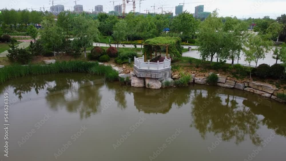 Lakeside observatory of artificial lake, slow cinematic aerial forward dolly view Lakeside observatory of artificial lake, slow cinematic aerial forward dolly view