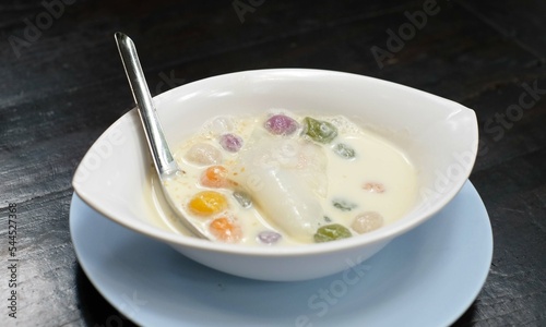 Popular and famous thailand dessert, Thai dumplings in coconut cream and egg on wood table