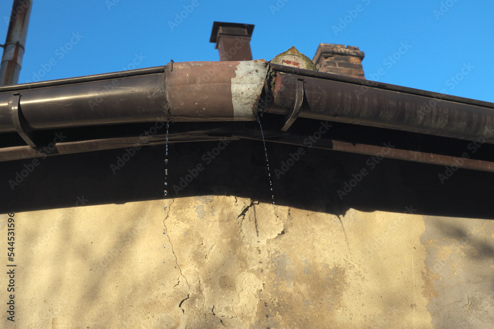 Leaky old gutter, badly repaired Stock Photo | Adobe Stock