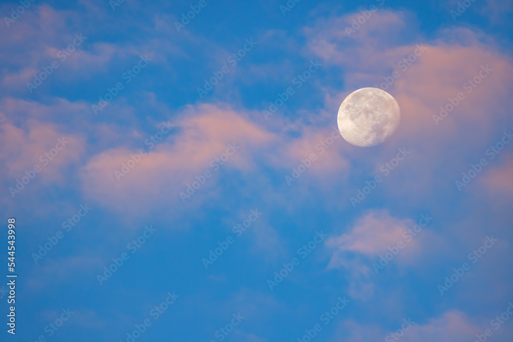 Blue sky with moon and clouds