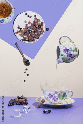 blackcurrant in a wooden plate. currants and gooseberries on a blue texture background. wooden bowl with berries. summer berries on the table. dessert with berries. dessert tea with berries
