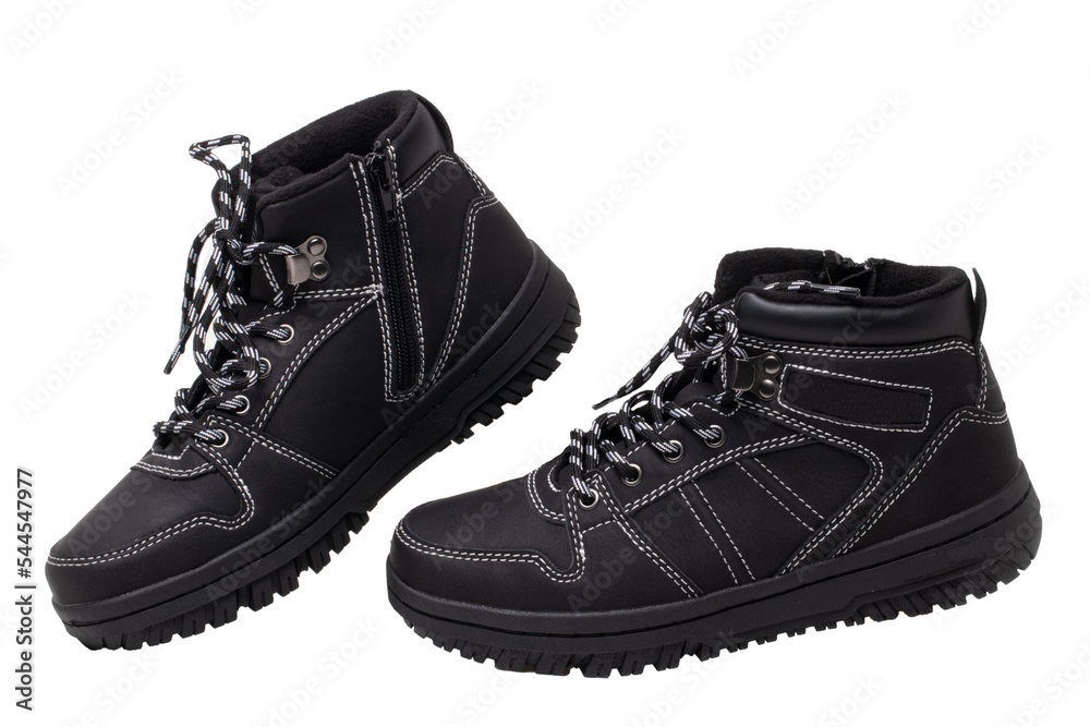 Winter boots. Close-up of a pair elegant black leather winter boots with laces and rivets isolated on white. Macro. Autumn shoe fashion for child boy. Winter boots. Close-up of a pair elegant black leather winter boots with laces and rivets isolated on white. Macro. Autumn shoe fashion for child boy.