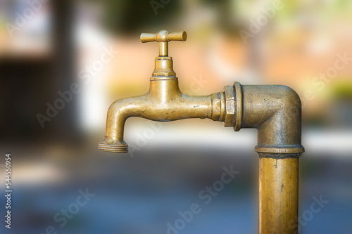 Detail of an old closed water brass faucet - image with copy space