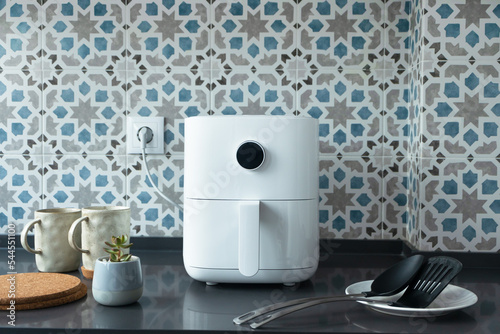 Air fryer machine in modern domestic kitchen. Technology home smart device