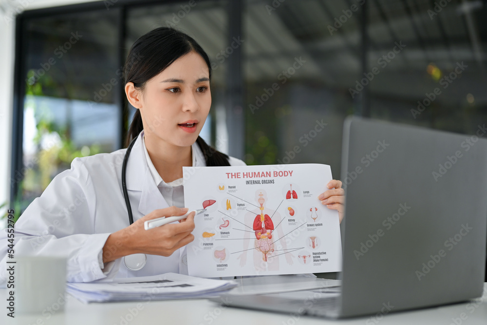 Asian female doctor having a medical webinar with her team, working and using laptop. Asian female doctor having a medical webinar with her team, working and using laptop.