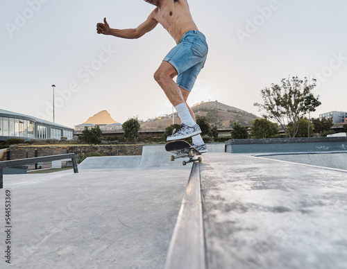 Skater, fitness and feet of man skateboarding in a park for fun, adventure and fitness. Sports, active and training of a guy using a board to skate outside in an urban city or town for exercise