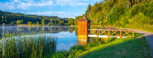 Idyllic sunny and hazy morning at the water. Chrastna pond, Czech: Chrastensky rybnik, Czech Republic