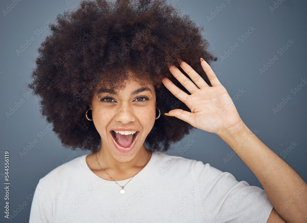 Hand, wave and excitement with an afro black woman in studio on a gray background greeting with a smile. Portrait, hair and happy with an attractive young female waving to welcome or say hello Hand, wave and excitement with an afro black woman in studio on a gray background greeting with a smile. Portrait, hair and happy with an attractive young female waving to welcome or say hello